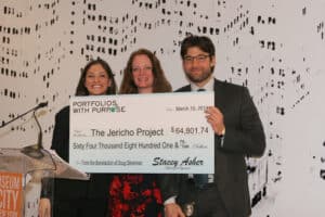 Portfolios With Purpose founder Stacey Asher (left) presents a check to the Jericho Project.